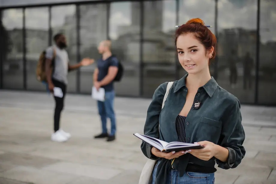 smiling-students-standing-with-notepad