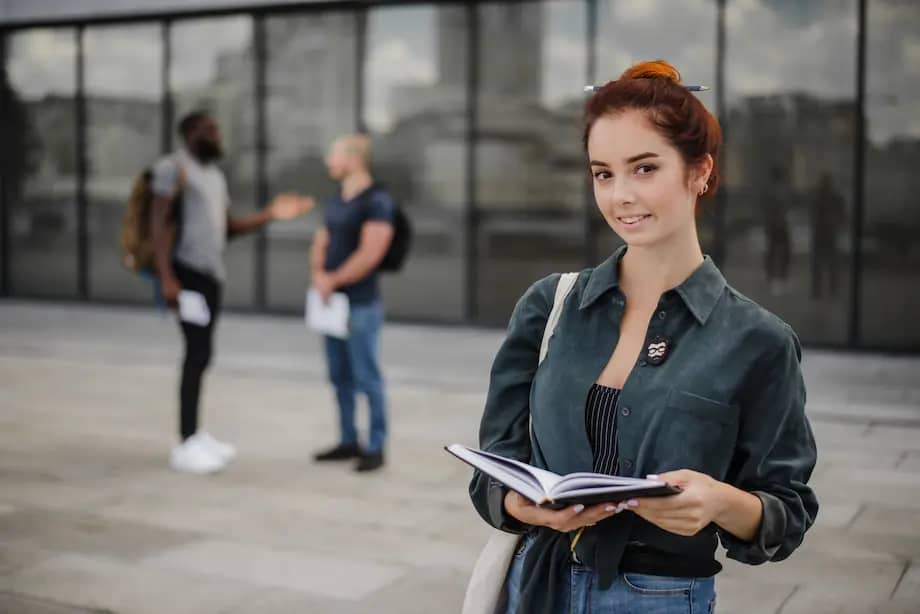 smiling-students-standing-with-notepad